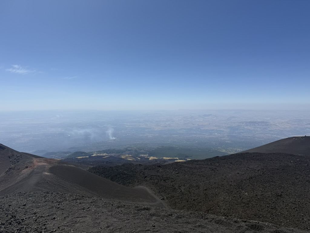 View of Sicilian valley and coastline from Mount Etna's summit