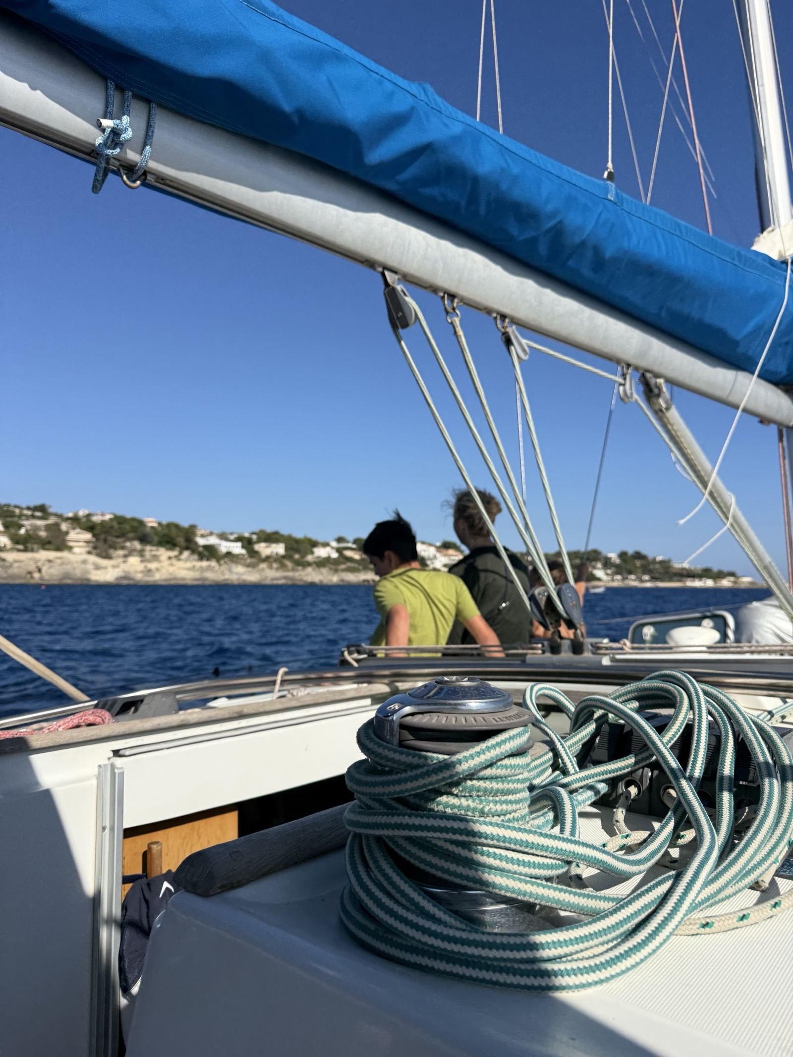 Sailing aboard Cornelia with the Sicilian coast on the horizon